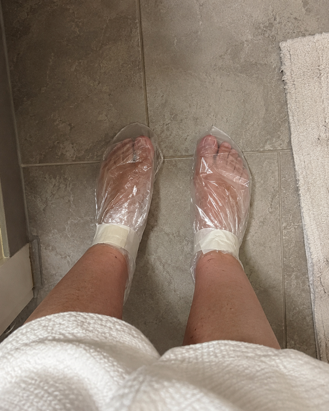 Feet wrapped in plastic bags to shower